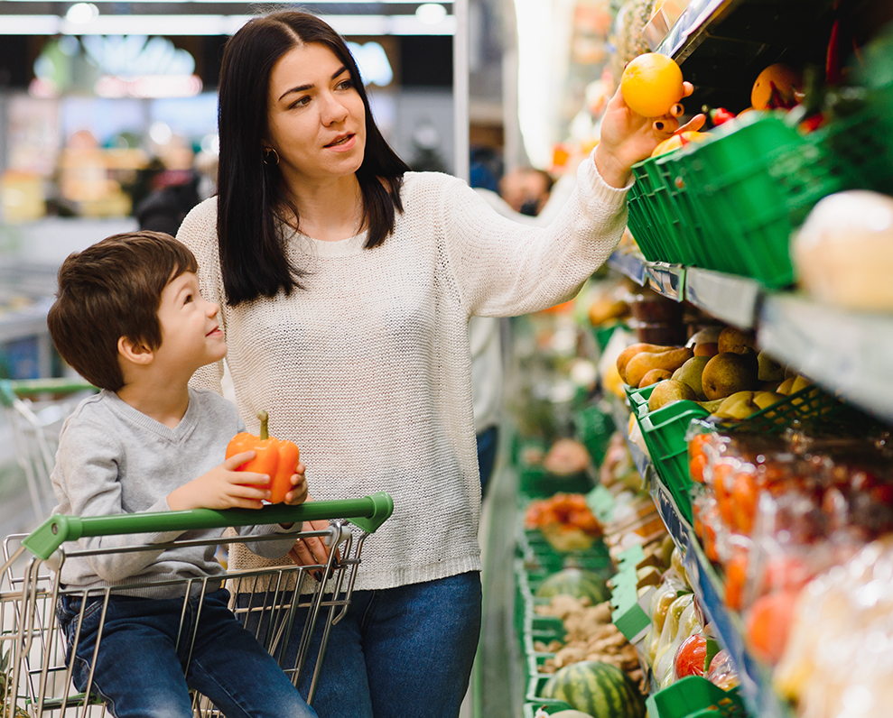 mother and son grocery shopping using WIC