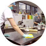 Women cleaning and food prepping in a commercial kitchen